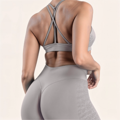 Chicletics ELITE CROSSBACK BRA shown on a mannequin, featuring a supportive crossback design in sleek athletic fabric.