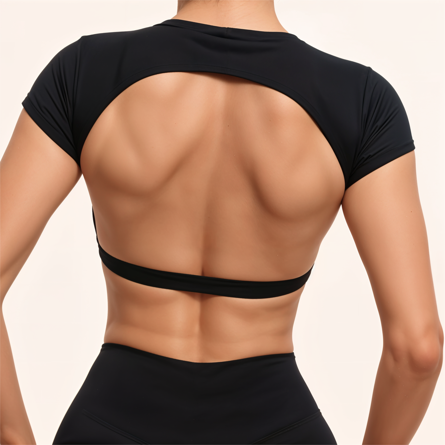 Chicletics core backless tee featuring a relaxed fit and open back design, made from soft, breathable fabric in a casual style.